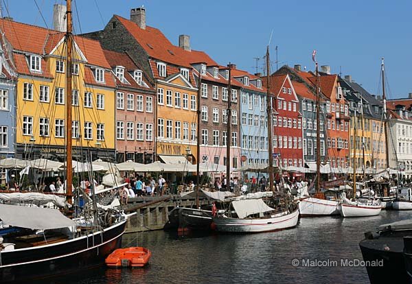 Old buildings by a canal now restored to give a new lease of life. Nyhavn, Copenhagen, Denmark